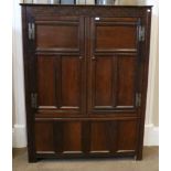 An 18th Century Joined Oak Livery Cupboard, with carved frieze above fielded cupboard doors