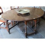 An Early 18th Century Oak Six-Seater Gateleg Table, with two rounded drop leaves to form an oval