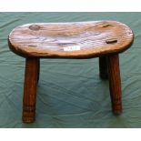 A 19th Century Elm Stool, of oval form, raised on four turned legs, 31cm by 18cm by 19cm