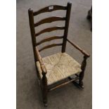 A 19th Century Child's Ash and Rush Seated Ladder-Back Rocking Armchair, with spindle arm