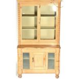 A Victorian Pine Dresser, the upper section with glazed doors enclosing a painted interior, the base