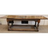 A 17th Century Joined Oak Refectory Dining Table, the plank top with cleated ends, raised on