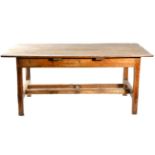 An 18th Century Rustic Elm and Pine Dining Table, with single frieze drawer above a plain frieze,