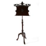 An Art Nouveau Mahogany Music Stand, late 19th century, the adjustable rest decorated with scrolling