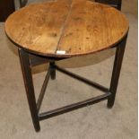 An Early 19th Century Elm and Oak Circular Cricket Table, the two piece top raised on triangular