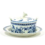 A Worcester Porcelain Butter Tub, Cover and Stand, circa 1775, printed in underglaze blue with the