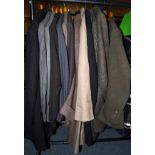A quantity of assorted gents mainly green wool, checked or tweed suits and overcoats, labels include