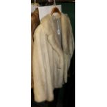 A white mink jacket with decorative paste set buttons