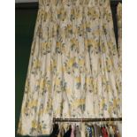 Two pairs of yellow floral glazed cotton curtains with tie backs, lined and interlined