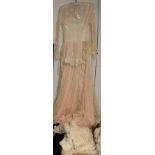 Early 20th century white net and lace mounted long sleeved dress, with pink net underskirt; pretty