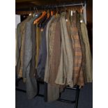 A quantity of assorted gents mainly green wool, checked or tweed jackets, wool trousers and three