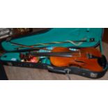 A cased violin and two bows