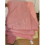 A pink and yellow reversible satinised cotton quilt, 255cm by 180cm