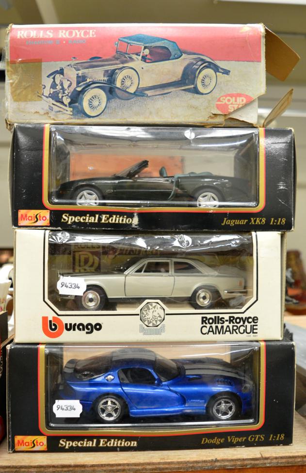 A group of four Burago and other model cars