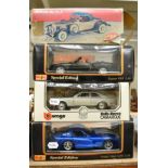 A group of four Burago and other model cars