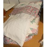 A large modern patchwork quilt with pink floral border