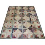 A Victorian Log Cabin Patchwork Quilt, using printed cottons in blues, purples, reds, pinks and