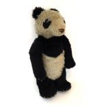 Circa 1930s Merrythought Panda, with brown stitched nose, jointed arms, four claws to all four paws,