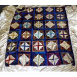 Early 20th Century Silk Log Cabin Patchwork Bed Cover, within a blue velvet frame, attached cream