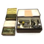 R & J Beck Student Microscope in box with Table of Magnifying Powers on lid; together with various