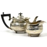 A bachelors silver teapot, Goldsmiths and Silversmiths, Sheffield 1916; and a George III style