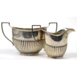 A silver cream jug and sugar bowl, Henry Moreton, Birmingham 1914, oval part fluted form, the