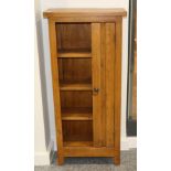 An Oak CD Cabinet, modern, with three fixed shelves flanked by a cupboard door fitted with slides to
