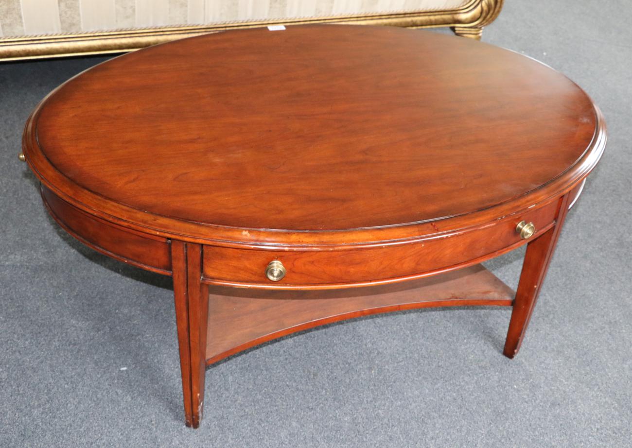 A Multiyork Mahogany and Crossbanded Coffee Table, modern, of oval form with two drawers, raised