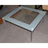 A Ligne Roset Metamorphic Glass Top Coffee Table, modern, with a frosted border above brushed