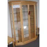 A Beech Display Cabinet, modern, of canted form with etched glazed doors enclosing five adjustable