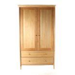 A John Lewis Essence Oak Two Door Wardrobe, of recent date, the moulded cornice above two cupboard