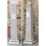 A Pair of Stone Obelisks, modern, of graduated form, with moulded stepped bases standing upon square