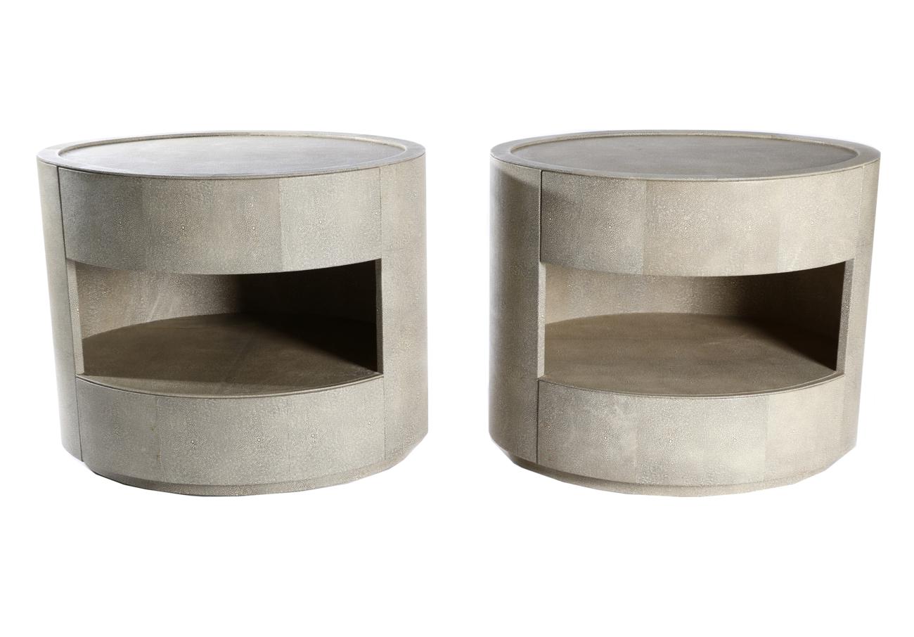 A Pair of Leather Shagreen-Effect Oval Bedside Tables, each with two bowfront drawers and raised