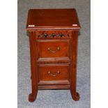 A Carved Hardwood Chest, modern, with two drawers above scrolled feet, 38cm by 34cm by 61cm