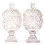 A Pair of Cut Glass Jars and Covers, early 19th century, of ovoid form with allover strawberry