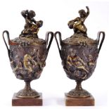 A Pair of Bronze Twin-Handled Urn Shaped Vases and Covers, after the Antique, cast with Bacchanalian