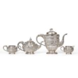An Indian White Metal Three PIece Tea Service, late 19th century, spherical form, decorated with