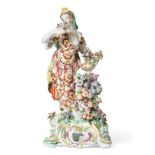 A Bow Porcelain Figure of Flora, circa 1765, from a set of The Senses, the standing figure wearing