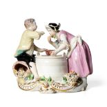 A Chelsea Porcelain Figure Group of a Boy and Girl, circa 1755, she standing, he sitting on a basket