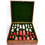 A Chinese Export Stained and Natural Ivory Chess Set, circa 1900, of figural form, each piece on a