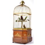 A Coin Operated Singing Bird Automata, probably French, circa 1900, the bird with red plumage