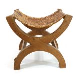 Mouseman: A Robert Thompson Oak Cross Framed Stool, the slung hide seat supported by two X legs,
