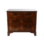 A George II Walnut and Oyster Veneered Three Drawer Straight Front Chest of Drawers, early 18th