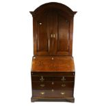 A George III Oak Bureau Bookcase, 3rd quarter 18th century, the moulded architectural pediment above