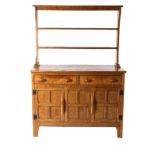 King Post of Burton Leonard: A Robert E Ingham English Oak Dresser, the open back rack with two