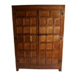 Mouseman: A Robert Thompson Panelled English Oak Wardrobe, with half penny moulding above two doors,