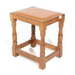 Mouseman: A Robert Thompson English Oak Dressing Table Stool, with upholstered cow hide seat, on