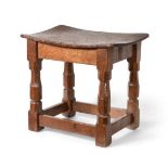 Mouseman: A Robert Thompson Burr Oak Dish Top Stool, on four octagonal legs joined by stretchers,