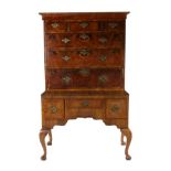 A George II Style Walnut and Featherbanded Chest on Stand, the moulded cornice above three short and