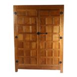 Mouseman: A Robert Thompson Panelled English Oak Wardrobe, with half penny moulding above two doors,